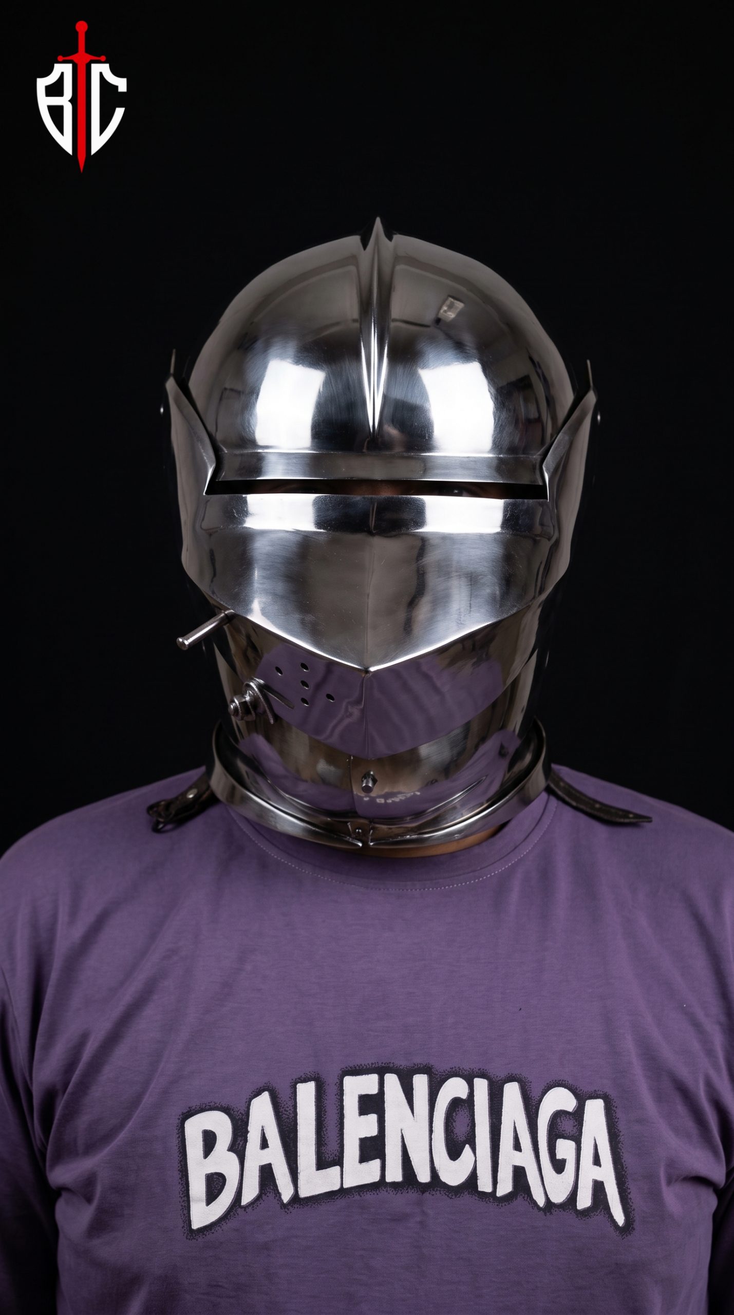 15th century armet helmet front view worn on fighter showing open visor with horizontal sight slit, rounded skull with raised medial ridge, and integrated articulated gorget lames, steel combat helmet for SCA and Buhurt