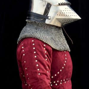 Pig face bascinet helmet front view with visor raised showing white quilted padded liner inside, riveted chainmail aventail covering neck, and pointed conical steel skull with chain stays